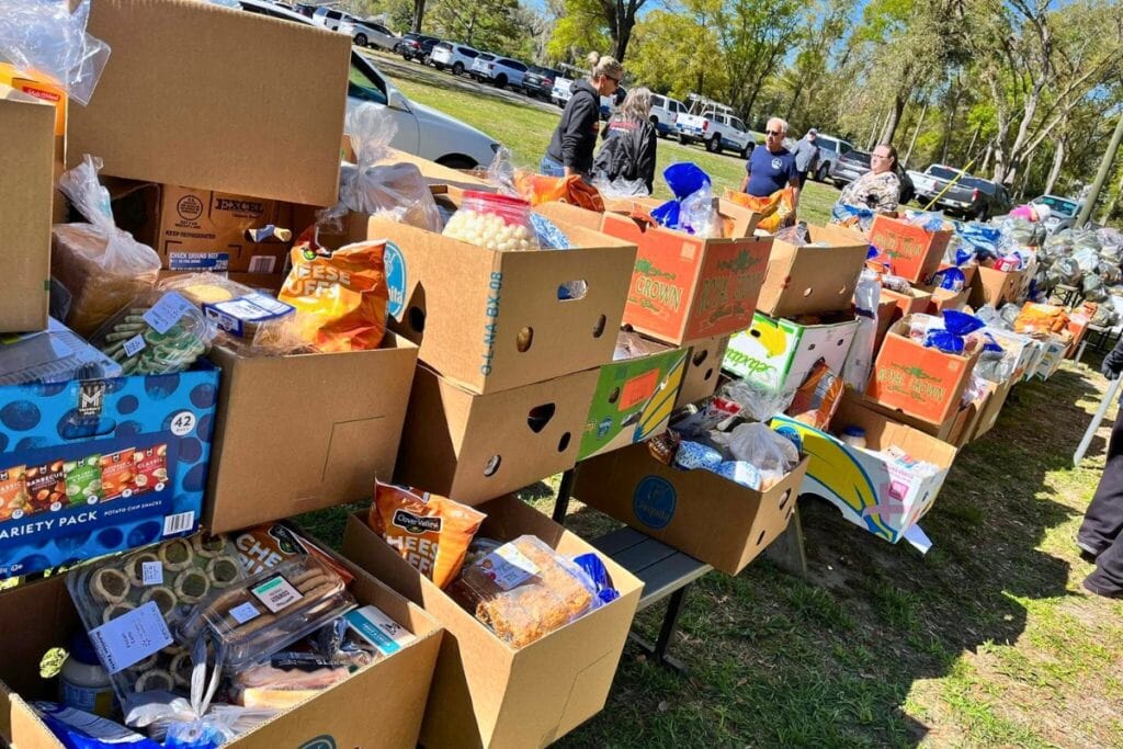 Volunteers distribute boxes of food from the Deeper Purpose food bank. Courtesy of DPCC