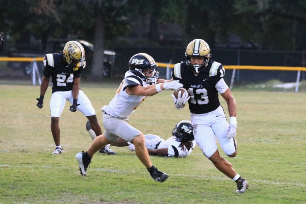 A Richmond Hill defender tries to tackle Buchholz's Justin Williams.