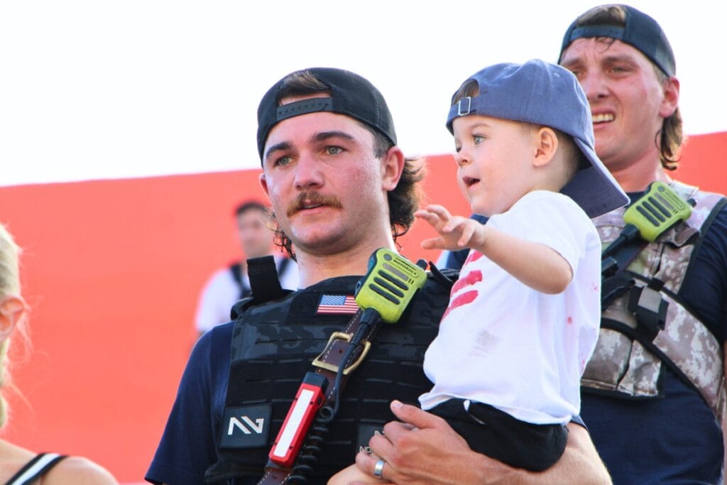 A firefighter climbs stairs with his son at Ben Hill Griffin Stadium in 911 remembrance. Photo by Lillian Hamman