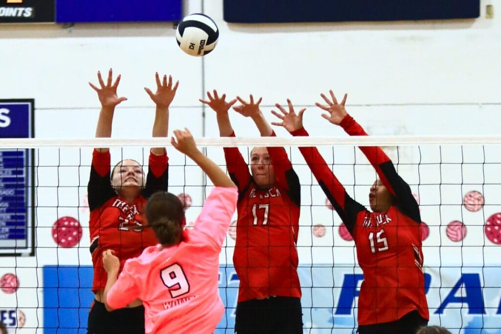 Saint Francis Catholic's Gianna Morali (9) with a hit against The Rock's Alexis Rhoden (23), Brianna Stevens (17) and Holdyn Moore (15). Photo by C.J. Gish