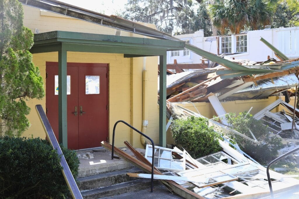 The roof and large sections of the walls were torn down by noon on Tuesday.