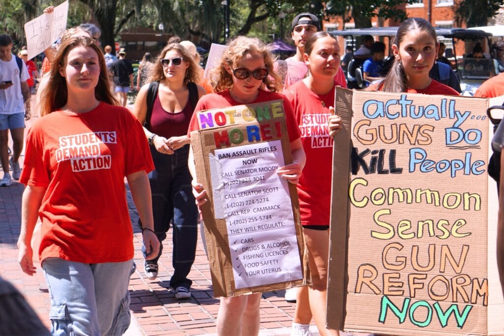 University of Florida Students Demand Action members lead the march through Plaza of the Americas on Friday. The group, with Alachua County’s Moms Demand Action volunteers and passersby, held signs and advocated for an end to gun violence.