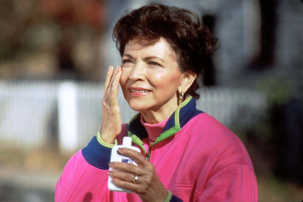 Woman applying sunscreen.