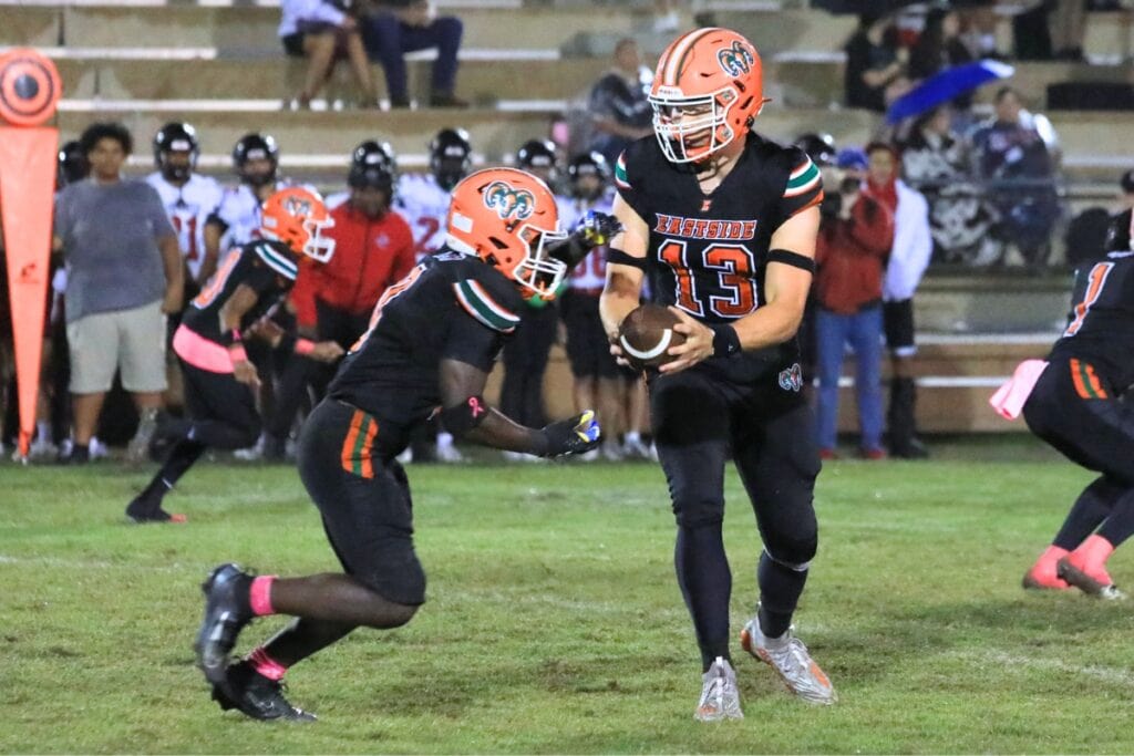 Eastside quarterback Nelson Tambling hands the ball off to Javaris Gardner. Photo by Seth Johnson