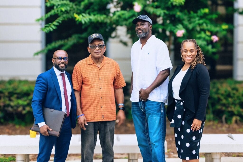 Florida Rights Restoration Coalition representatives meet with Alachua voters RB Banks (second from left) and Antonio Hall (third from left) to pay their outstanding fines. Courtesy of Florida Rig
