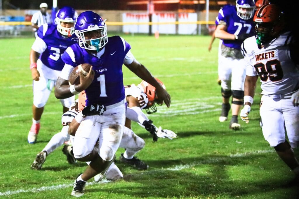 Gainesville's Dwight Jenkins (1) with a third-quarter run against Leesburg. Photo by C.J. Gish