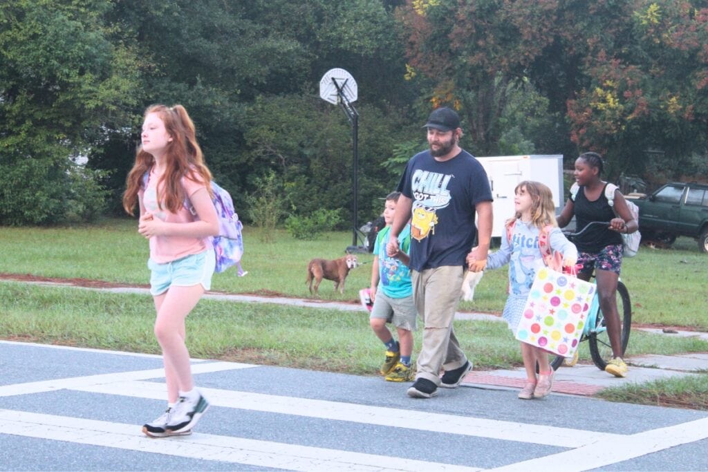 Students and parents walk across the crosswalk in front of High Springs Community School on Tuesday morning. Photo by Nick Anschultz