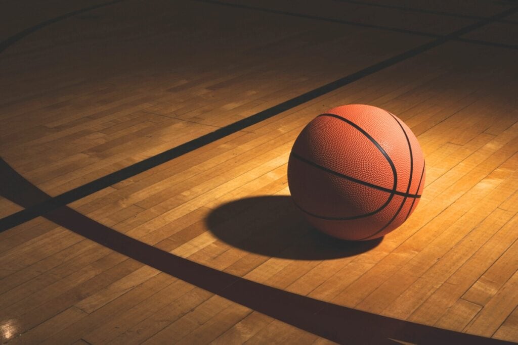 Basketball on court next to line. Metro Creative