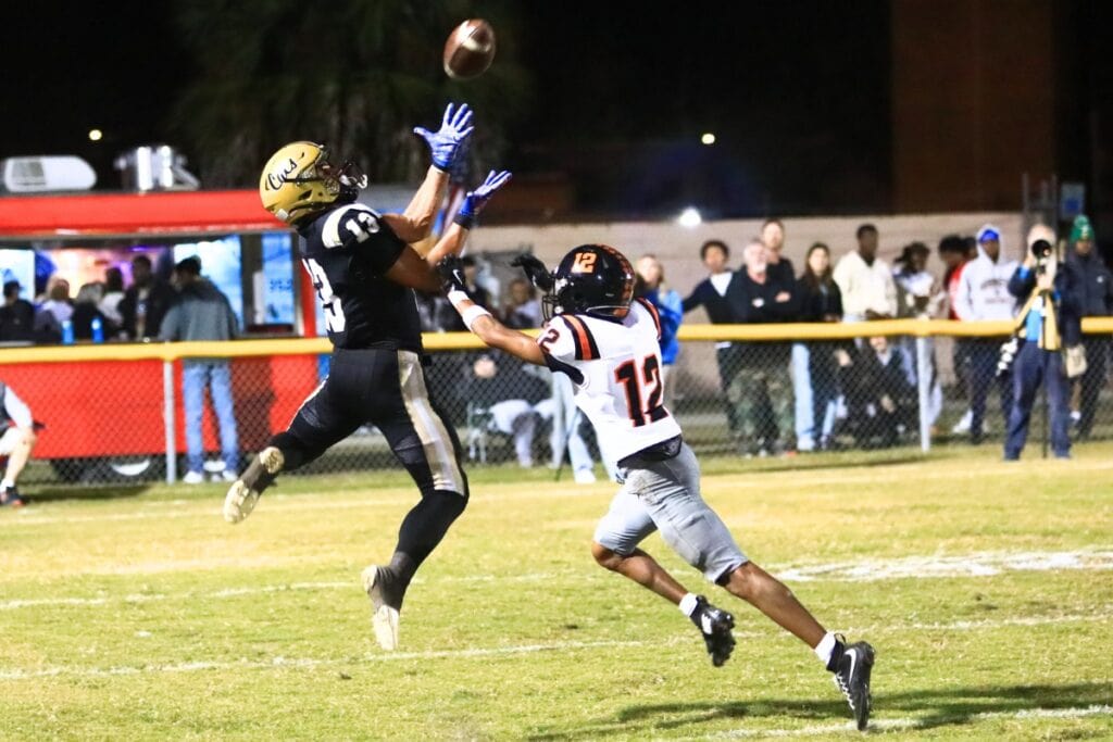Buchholz's Justin Williams (13) goes up for a touchdown reception in the second quarter against Oviedo in the Region 1-6A Quarterfinals. Photo by C.J. Gish