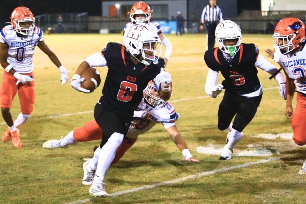 Hawthorne's Raheem Moore (6) slips past Branford defenders for a first down in the Rural Regional Semifinals. Photo by C.J. Gish