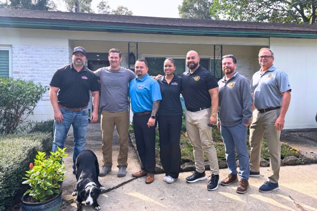 Mike S., second from left, with the Operation Healing Forces and Action Roofing teams on hand to surprise him with a new roof Thursday. Photo by Kirsten Rabin