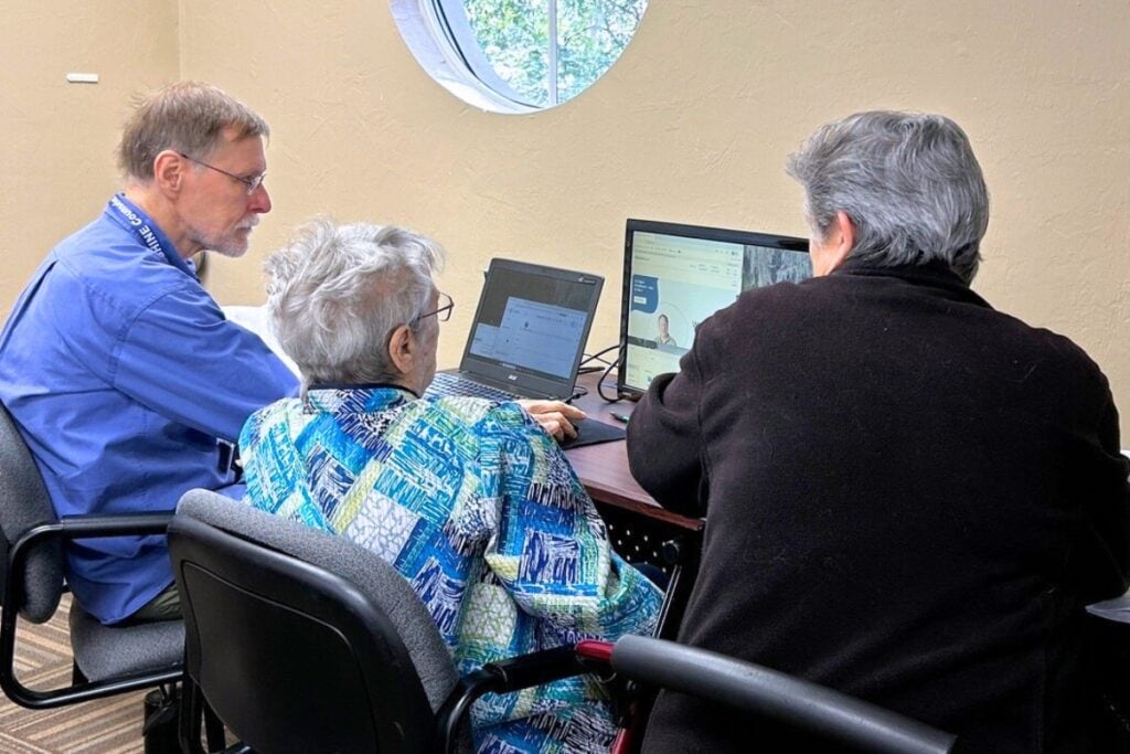 SHINE counselor Ben Koopman meets with June Sassaman, center, and her daughter, Joanne Watson. Photo by Ronnie Lovler