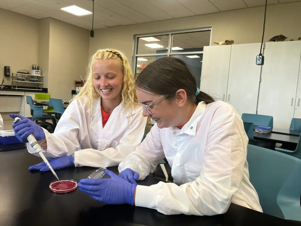 Two high school students in a lab