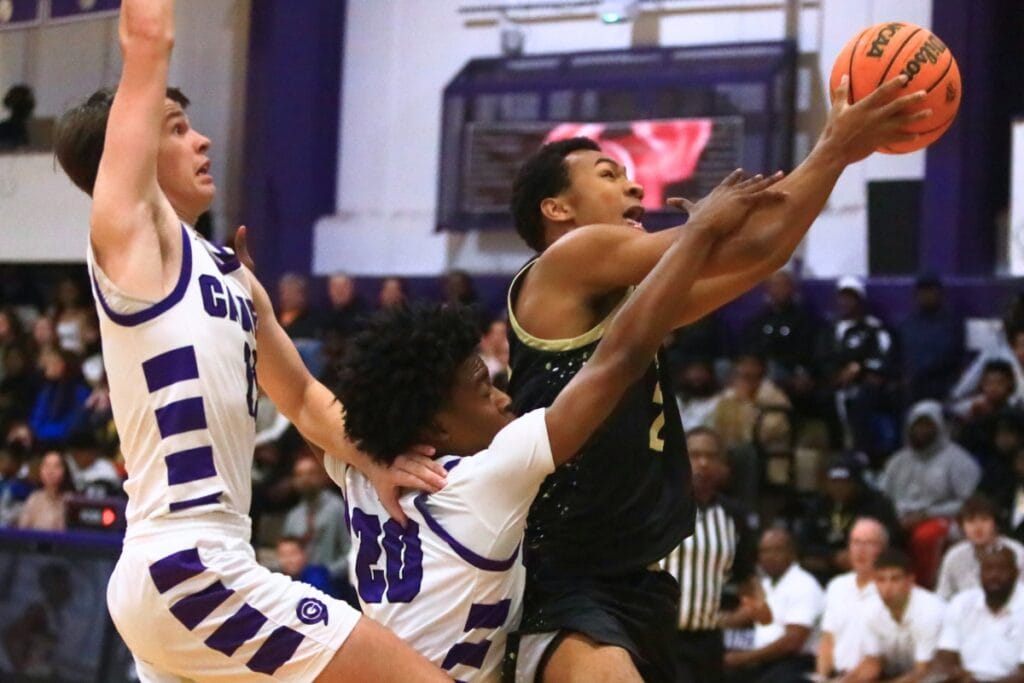 Gainesville's Kyle Pinter (11) and Anthony Jenkins Jr. (20) try to keep Buchholz's Collin Reynolds (23) from scoring. Photo by C.J. Gish
