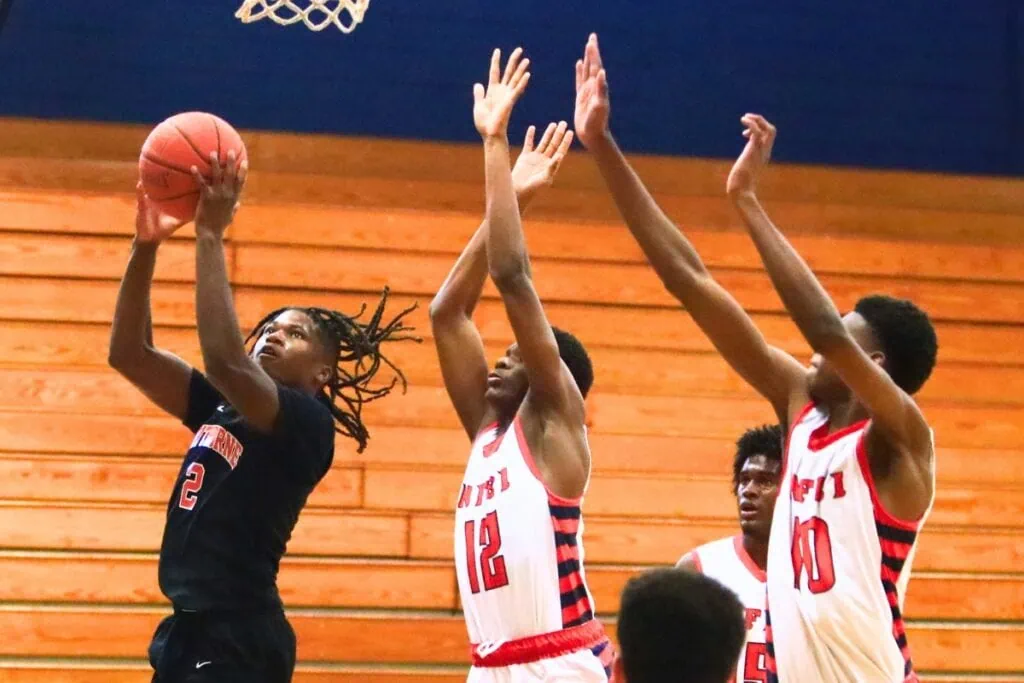 Hawthorne's Nathan Jennings (2) goes up for a basket against North Florida Education Institute (Jacksonville). Photo by C.J. Gish