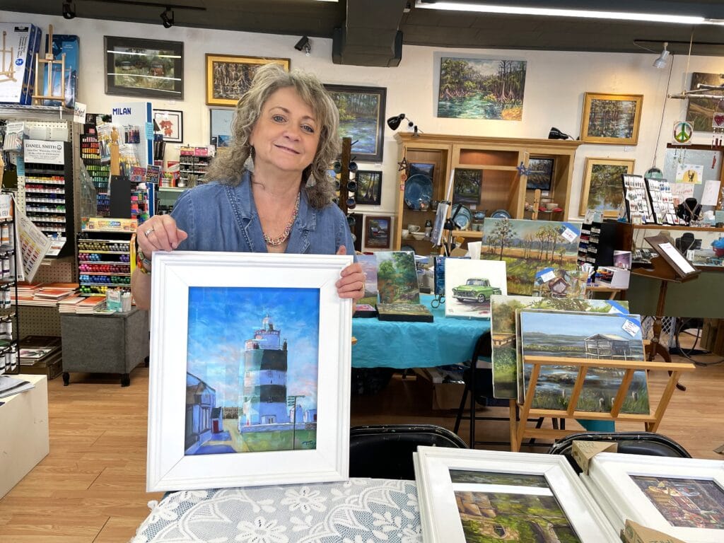 Tina Corbett with her painting of Hook Lighthouse seen during her trip to Ireland. Photo by Seth Johnson