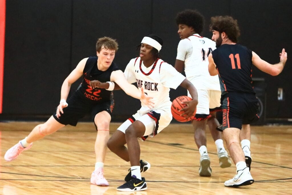 Trenton's Tyler Bullis (22) goes for a steal against The Rock's Kyroe Jordan (2). Photo by C.J. Gish 1