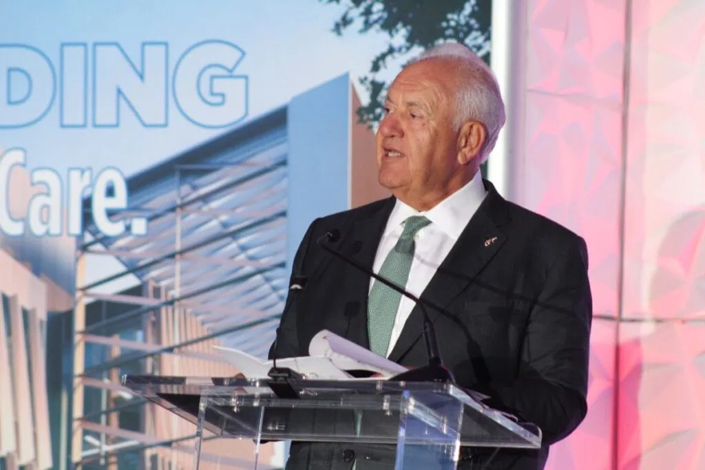 UF Board of Trustees Mori Hosseini speaks from behind a podium.