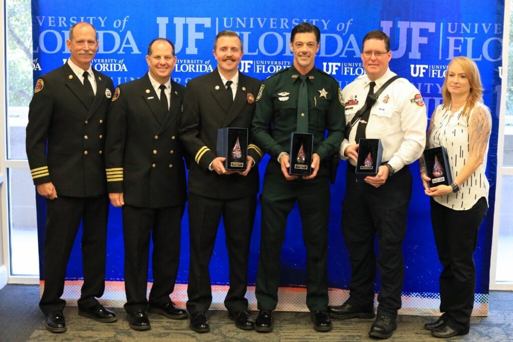Personnel from Gainesville Fire Rescue, Gainesville Police Department, Alachua County Fire Rescue and Alachua County Sheriff's Office receive the Win Phillips Town Gown Relations Award for gameday operations.