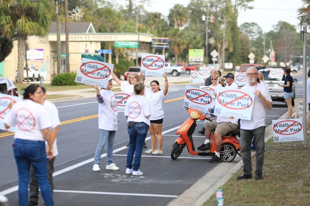 Protesters hold signs along SR 26.