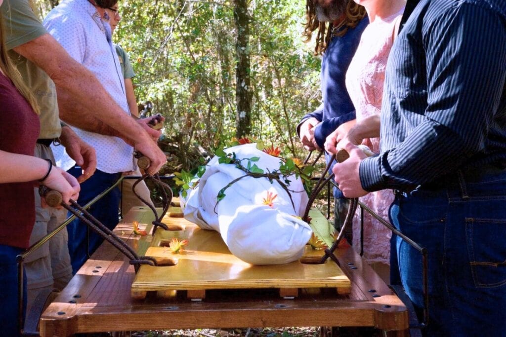 Mourners bringing a body to the burial site at Prairie Creek Conservation Cemetery. Courtesy of Prairie Creek Conservation Cemetery