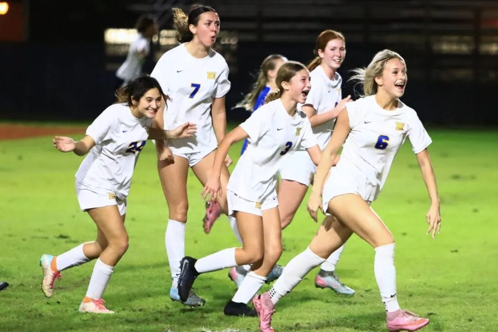 Newberry's Peyton Cremeans (6) is all smiles after tying the game 1-1 on a second-half header against P.K. Yonge. Photo by C.J. Gish