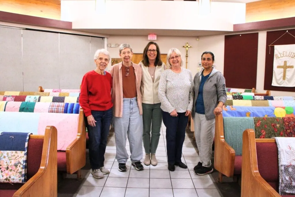 The Knotty Ladies prepared 39 quilts for a blessing before sending off to global relief missions. (From left) Betty Roode, Sue Dubinsky, Jennifer Boe, Robbin Walker and Ligi Jacob.