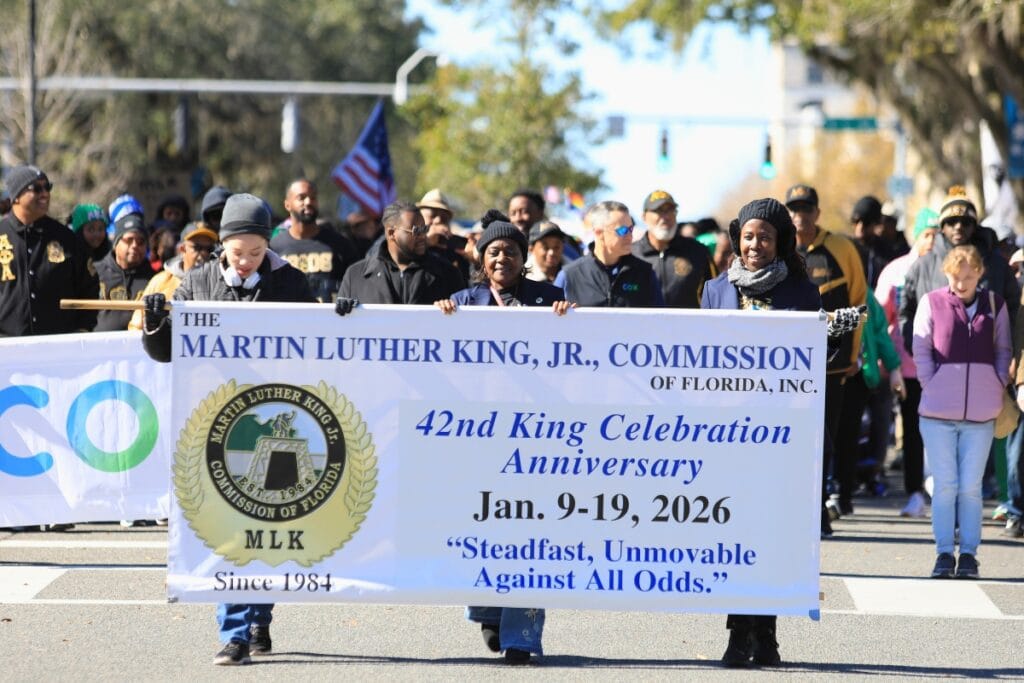 Members of the Martin Luther King, Jr., Commission of Florida start the parade down University Avenue.