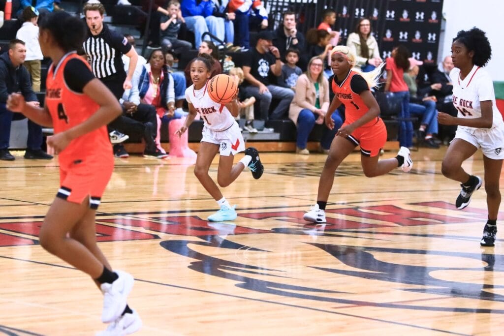 The Rock's London Williams (1) pushes the ball downcourt against Hawthorne. Photo by C.J. Gish
