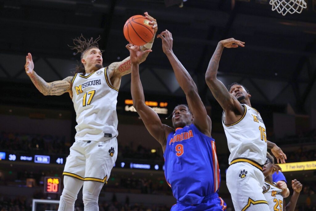 UF center Rueben Chinyelu fights for a rebound in the Gators' 76-74 road loss to Missouri on Saturday. Florida will try and avoid an 0-2 start in league play on Tuesday night at home against Georgia