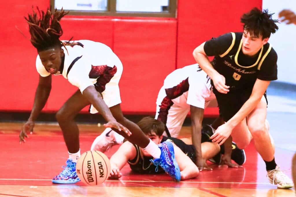Williston's Treston Jones (5) and Buchholz's Jacob Bromirski (0) go after a loose ball. Photo by C.J. Gish