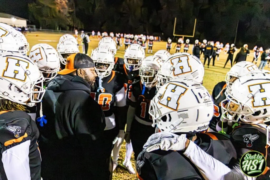 Hawthorne defensive coordinator Cedderick Daniels (talking to players in a huddle) was named the Williston head coach on Friday. Photo by HJ Scott