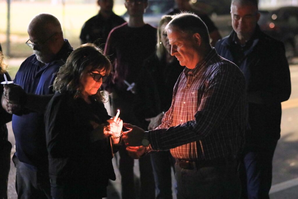 Kelly Gaudet, Scott's mother, lights the candle of Lt. Jeff Blundell at the 25th anniversary of Baird's death. Photo by Seth Johnson (1)