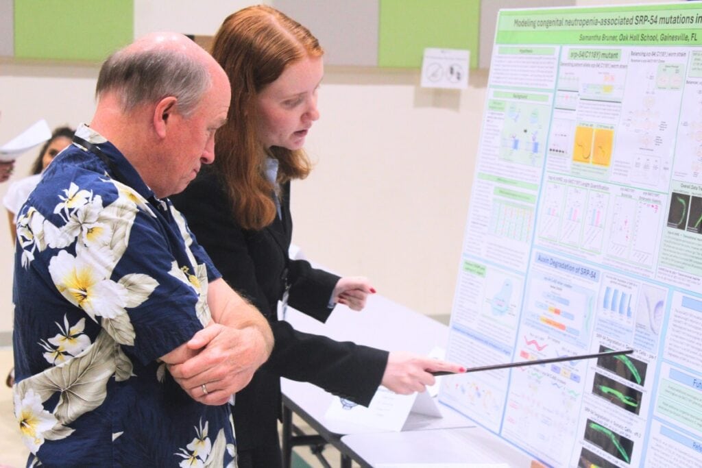 Samantha Bruner, a 10th grader at Oak Hall School, presents her science project to a judge on Thursday morning. Photo by Nick Anschultz