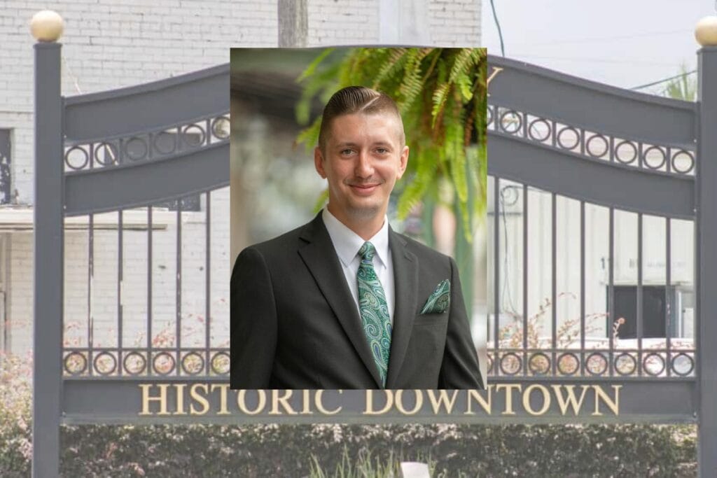 Headshot of Cody Gray in front of the Lake City Historic Downtown gate.