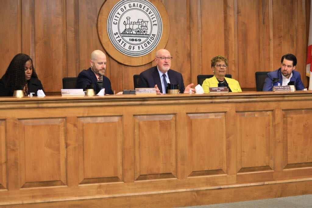 Mayor Harvey Ward (center) speaks during a Gainesville meeting in February 2026 with commissioners Desmon Duncan-Walker, Casey Willits, Cynthia Chestnut and Bryan Eastman (from left to right).