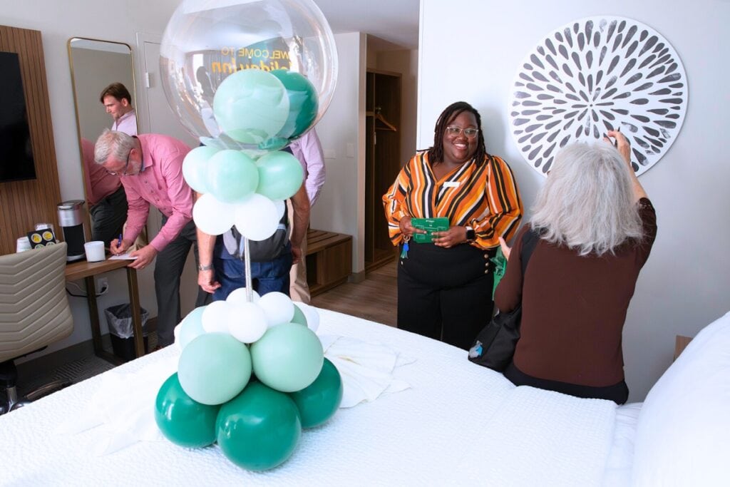 Hotel sales manager Leah Renwick, second from right, speaks with a guest in a “king room” during a tour. The hotel’s rooms and suites were gutted in the renovations, and they now feature expanded bathrooms as well.