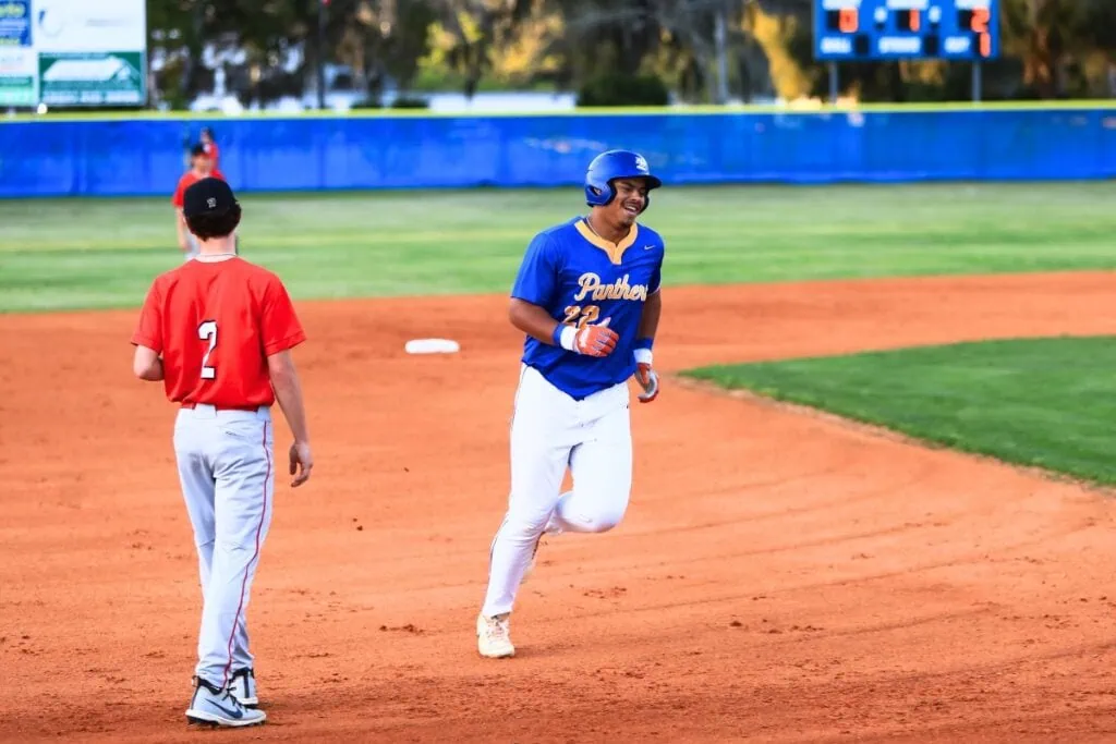 Newberry's Tavis Honeycutt (22) rounds the bases after hitting a 2-run home run in the bottom of the first inning against Santa Fe. Photo by C.J. Gish