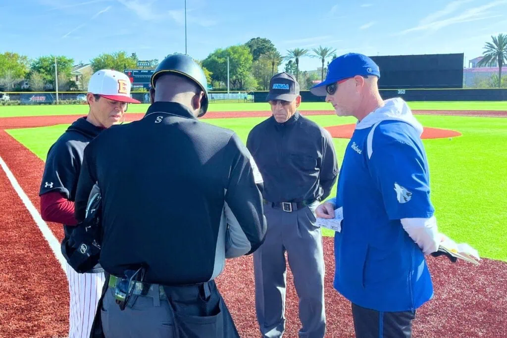 Saint Francis Catholic Academy coach Chris Santamarina (right) goes over pregame lineups at Episcopal (Jacksonville) on Wednesday. Photo by Mike Ridaught