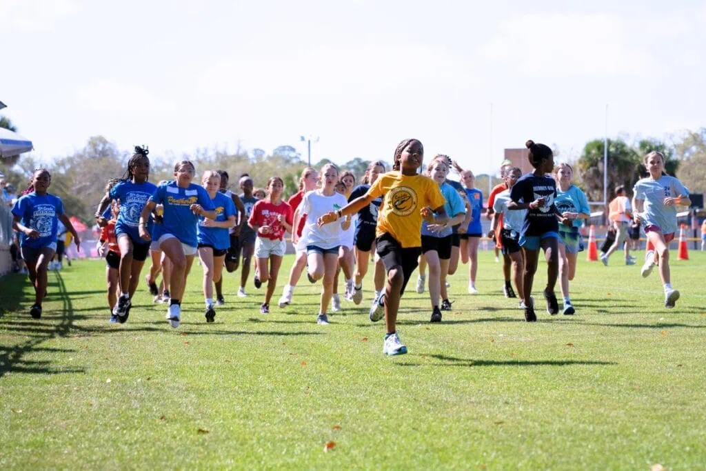 Students running a one-mile race around Citizens Field at Fifth Grade Field Day. Photo by Tim Rodriquez