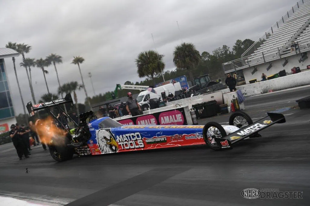A Top Fuel dragster takes off from the starting line during testing at Gatornationals.