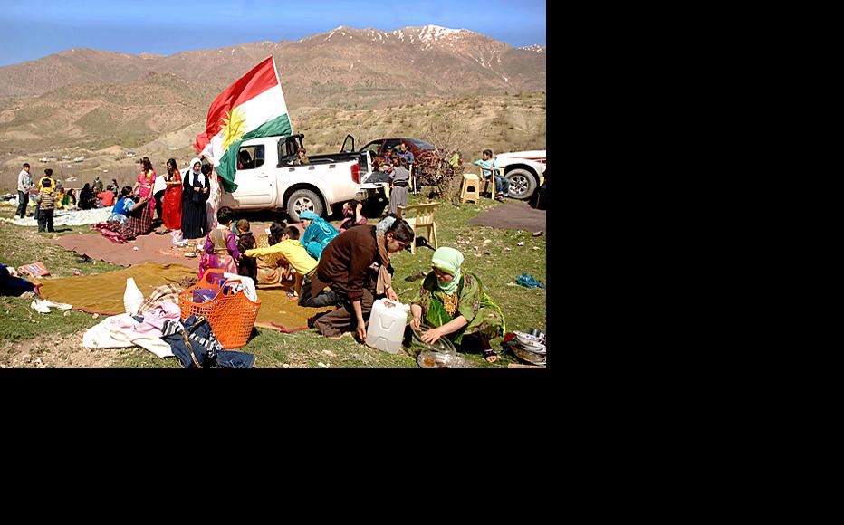 Families set up picnics on Qandil mountain in Sulaimaniyah province during the Nawrooz holiday on March 22, when the picnicking season begins in Iraqi Kurdistan. A Kurdish flag blows in the background.