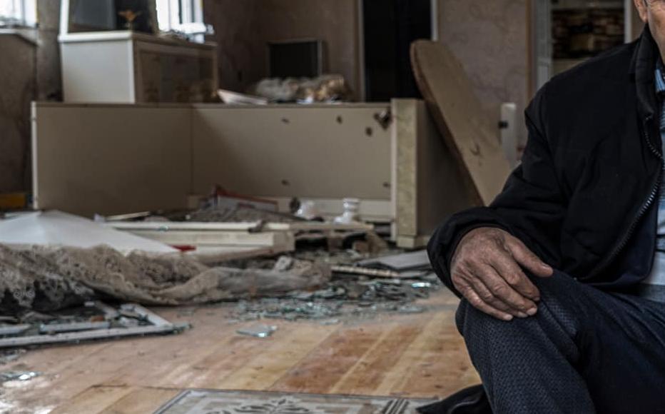 Etibar Huseynov, 58, sits in his house, which was hit by heavy artillery shelling during the war. He and his wife have been forced to live in a small room of the house, the only one that is still more or less intact, as they wait for the government to repair the house.