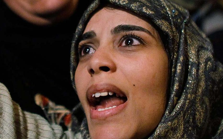 A woman cheers in Tahrir Square after it is announced that President Hosni Mubarak was giving up power on Feburary 11, 2011 in Cairo, Egypt.