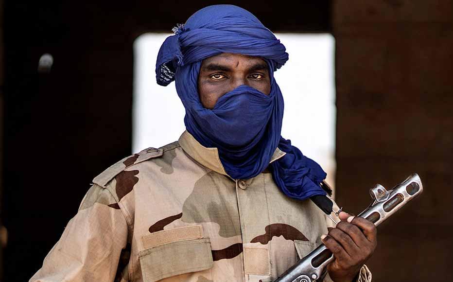A militiaman poses with his weapon at an informal demobilization camp in Sevare, Mali, on July 6, 2019. The camp is run by a businessman with the goal of shifting young Fulani men away from jihadism. © Marco Longari/AFP via Getty Images