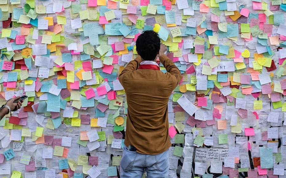 Demonstrators paste wishes on post-it notes on the "wish wall" in Tahrir Square on Nov. 22, 2019 in Baghdad, Iraq.