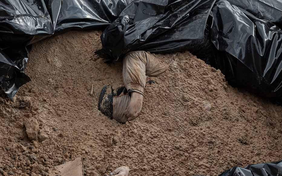 Bodies are seen inside a mass grave on April 4, 2022 in Bucha, Ukraine.