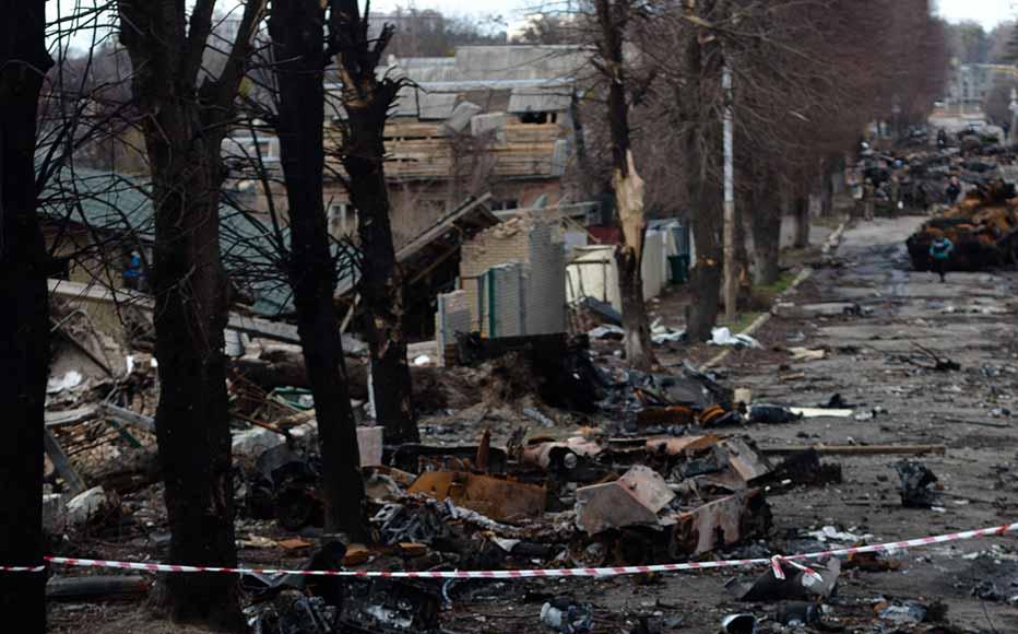 Ukrainian servicemen walk on the destroyed street on April 4, 2022 in Bucha, Ukraine. The Ukrainian government has accused Russian forces of committing a "deliberate massacre" as they occupied and eventually retreated from Bucha, 25km northwest of Kyiv.