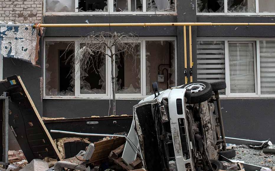 A man walks past a heavily damaged apartment building on April 4, 2022 in Bucha, Ukraine. The Ukrainian government has accused Russian forces of committing a "deliberate massacre" as they occupied and eventually retreated from Bucha, 25km northwest of Kyiv.