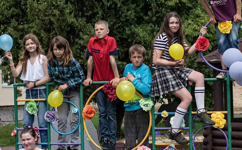 School students pose for a portrait with blue and yellow balloons in the colours of the Ukrainian national flag during Childrens Day activities on June 1, 2022 in Rusaniv, Ukraine.